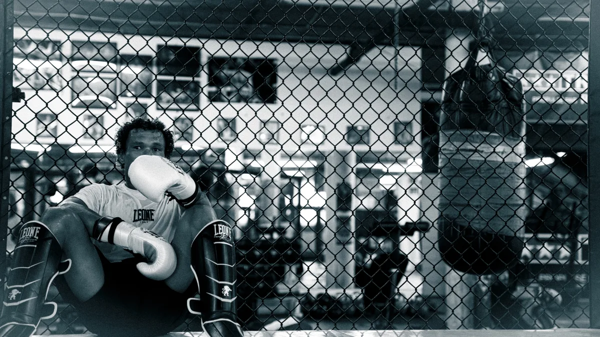 Fighter resting in the cage black and white