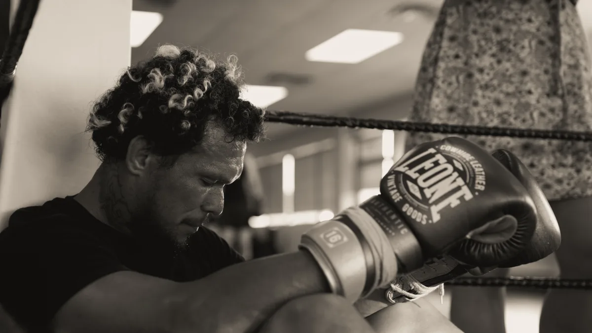 Boxer resting in the ring with LEONE gloves